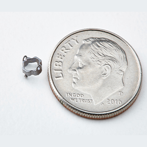 dime next to small part to show size comparison